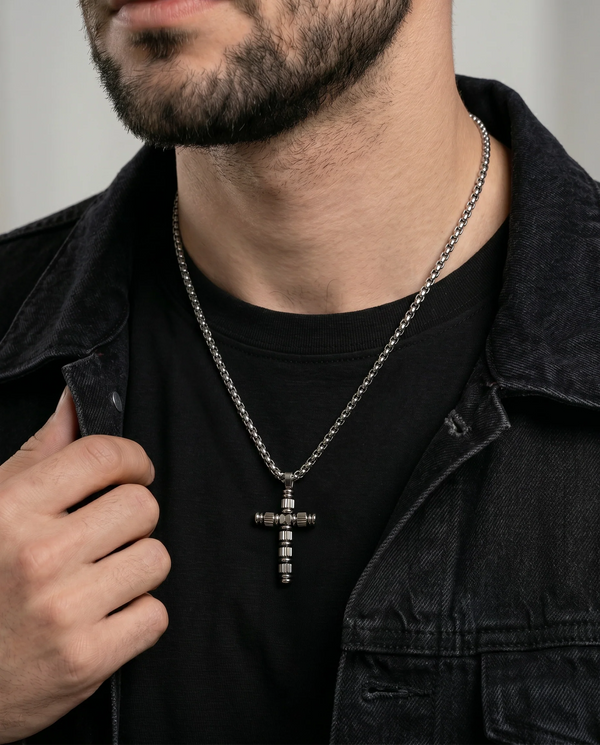 Close-up of stainless steel cable cross pendant