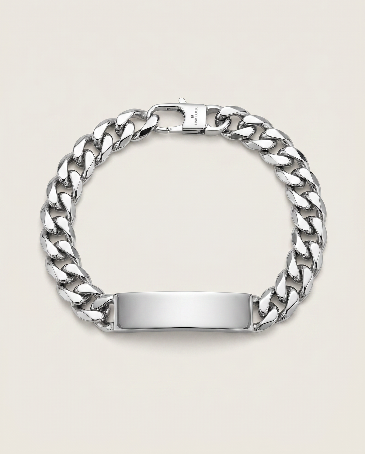 A silver-tone metal chain bracelet with a polished rectangular ID plate, shown on a light beige background.