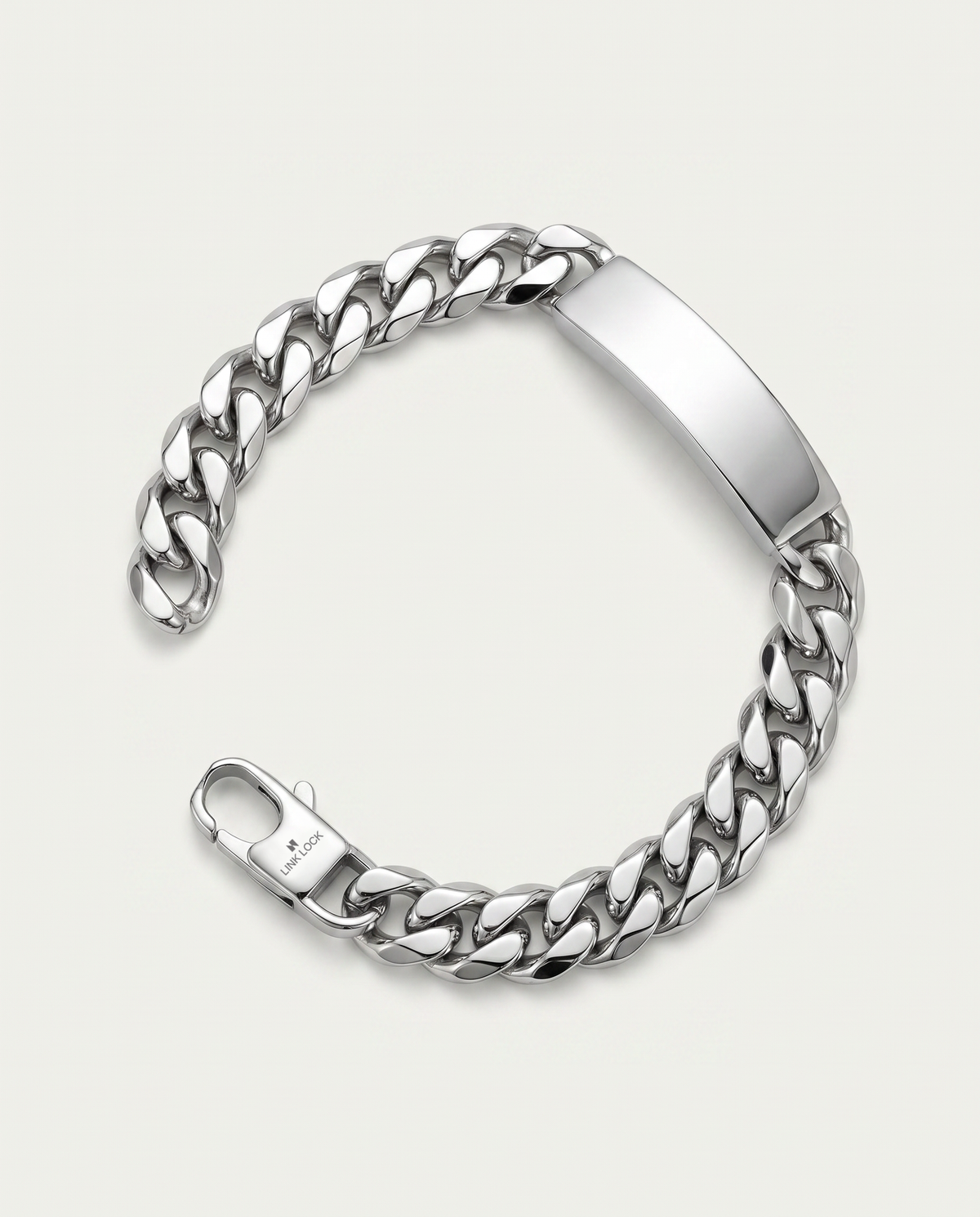 A silver-tone metal chain bracelet with a polished rectangular ID plate and a spring-ring clasp, shown on a light gray background.