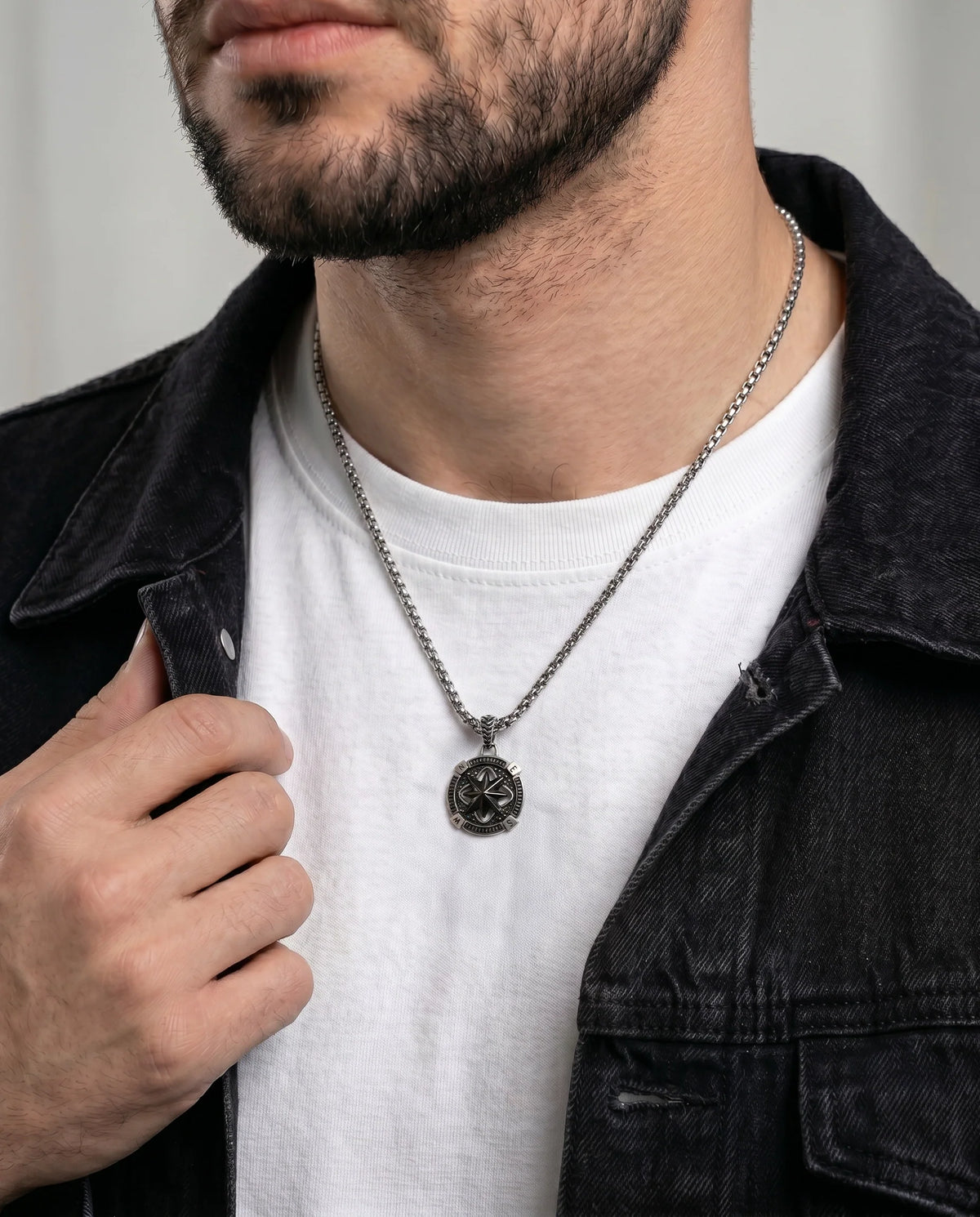 Close-up of black oxidized compass pendant