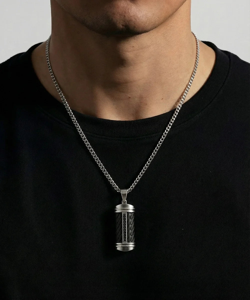 Close-up of black cubic zirconia dog tag pendant