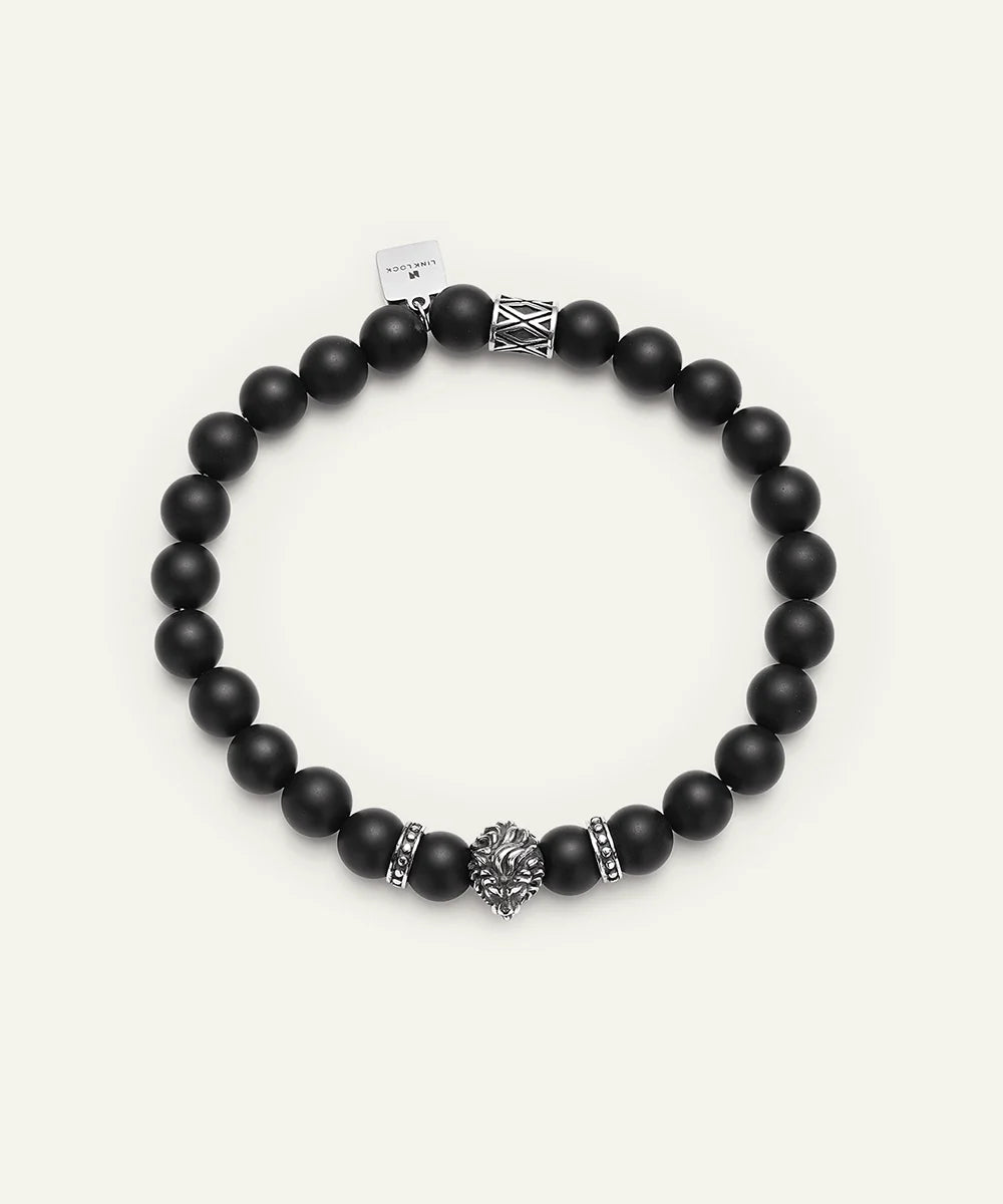 Black beaded bracelet with silver accents on a white background