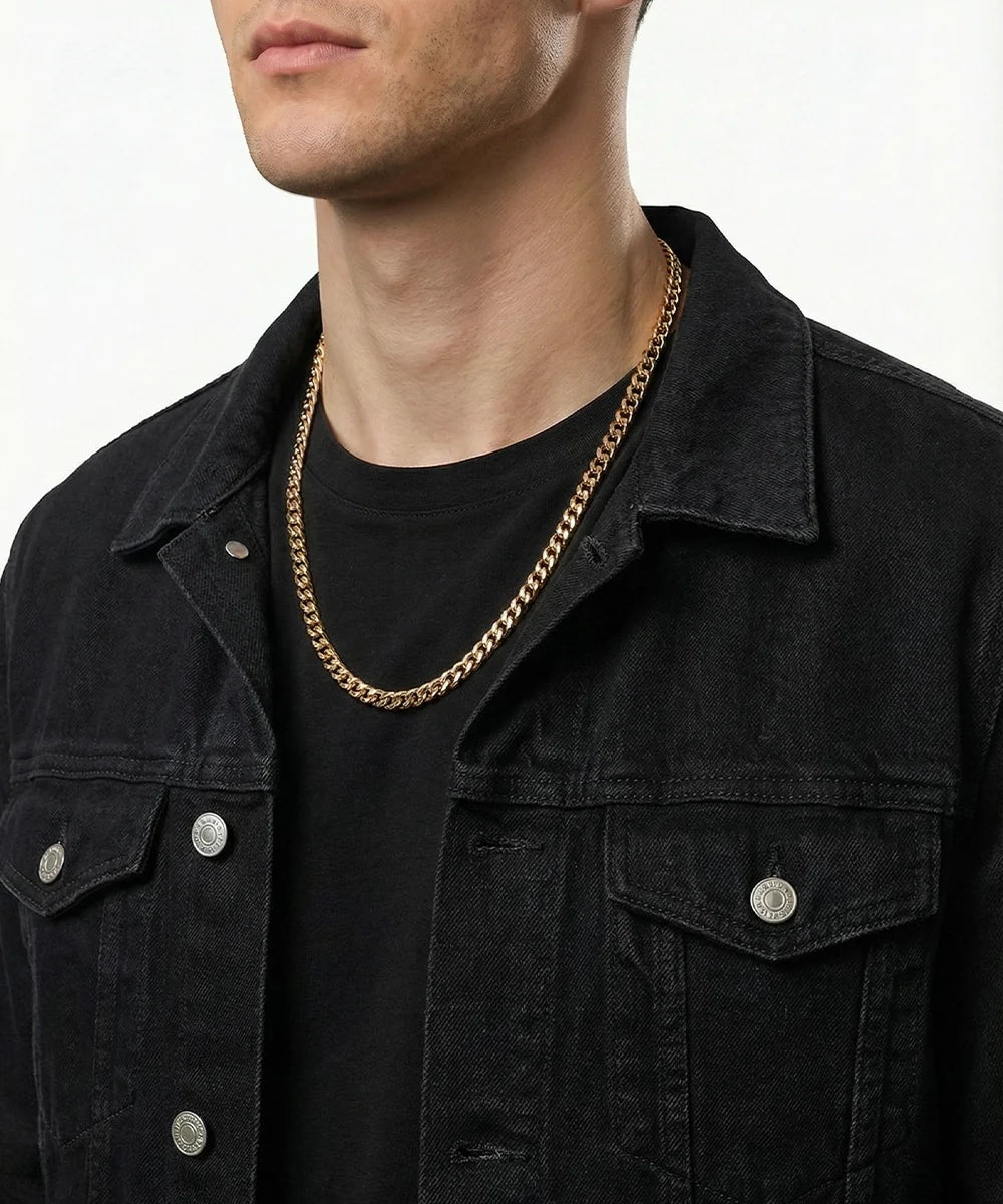 men's gold-toned Cuban chain necklace on model wearing black denim jacket