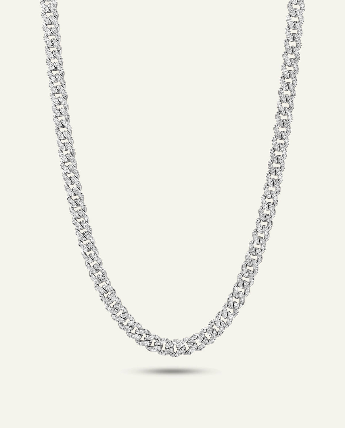 A silver-toned curb chain necklace displayed in a curved U-shape against a light off-white background.