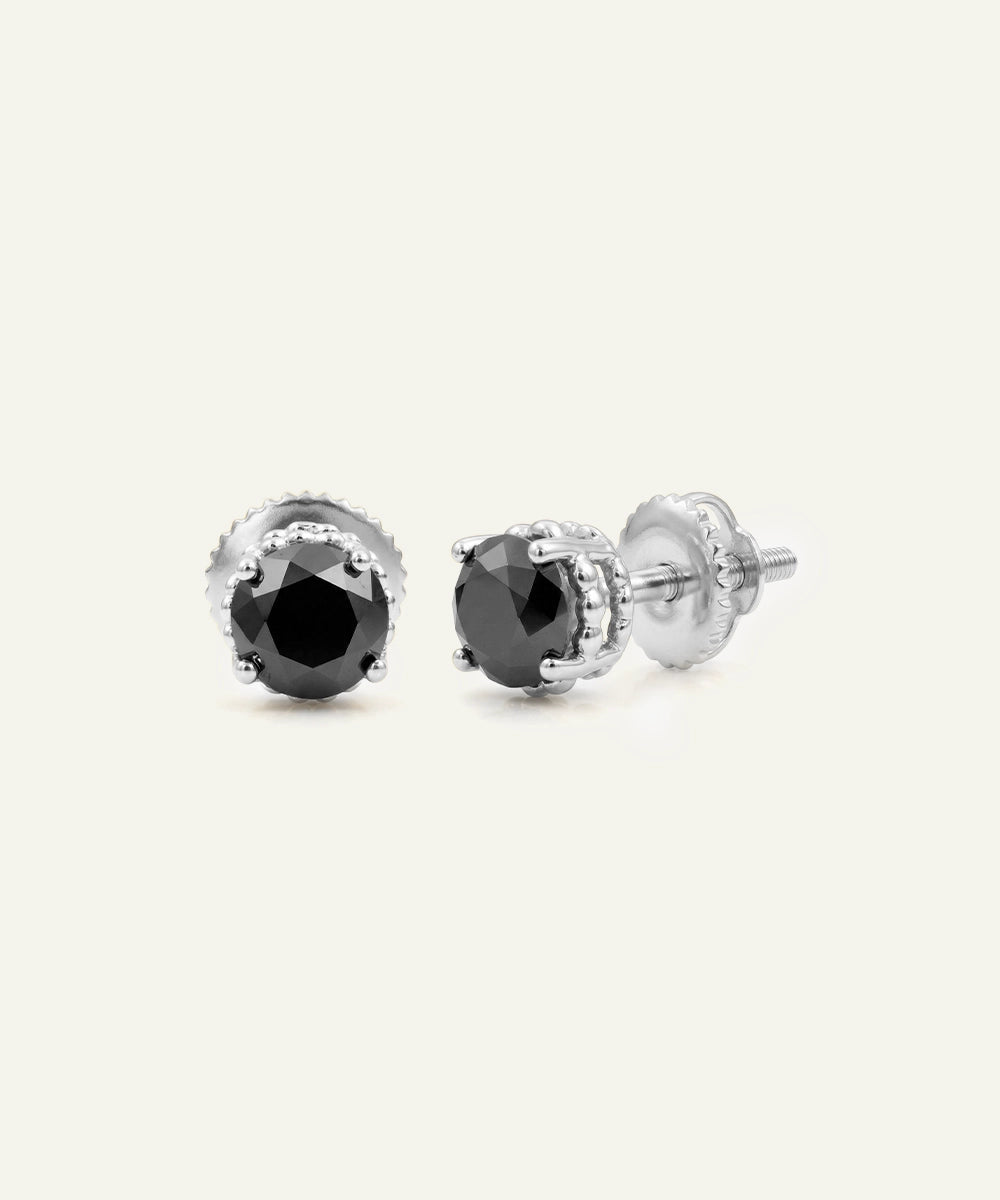 Close-up of men's round black diamond studs in silver finish