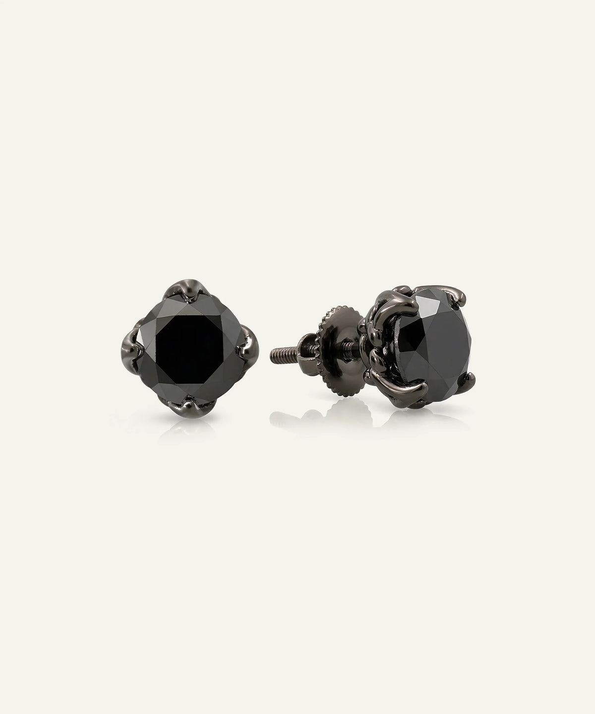 Close-up of men's round black diamond solitaire earrings