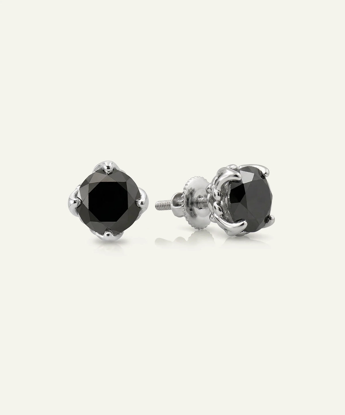 Close-up of men's black diamond studs in silver finish