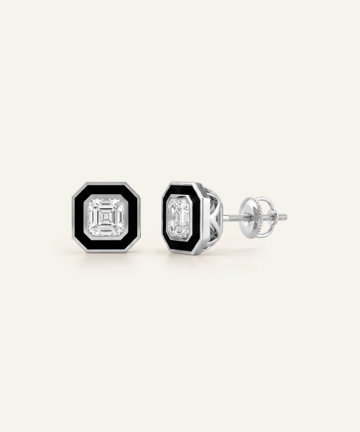 A pair of men's silver stud earrings featuring square clear central stones framed by black enamel borders, set against a light cream background.