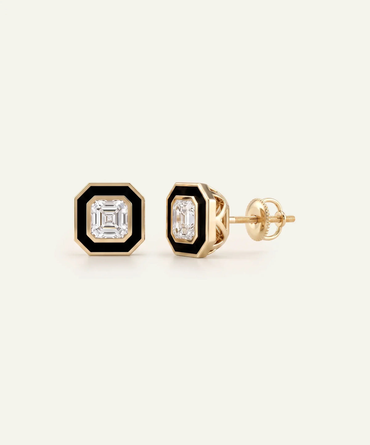 A pair of men's gold stud earrings featuring square Asscher-cut clear central stones framed by black enamel borders, set against a light cream background.