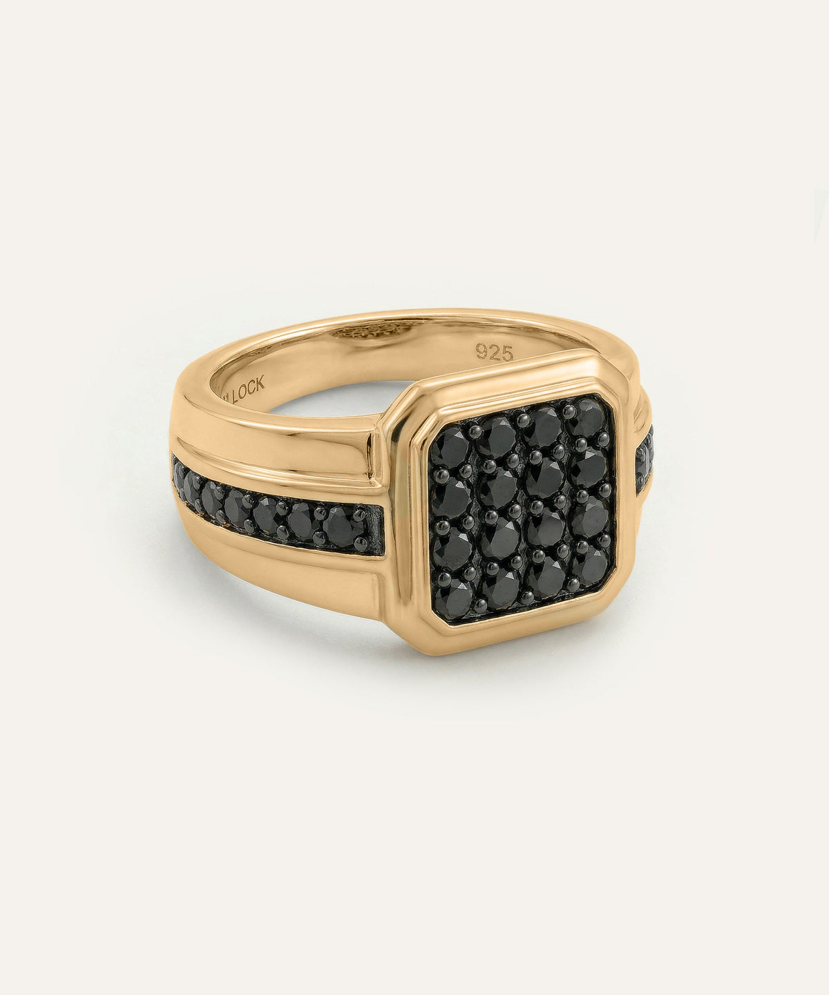 Gold ring with black gemstones on a white background