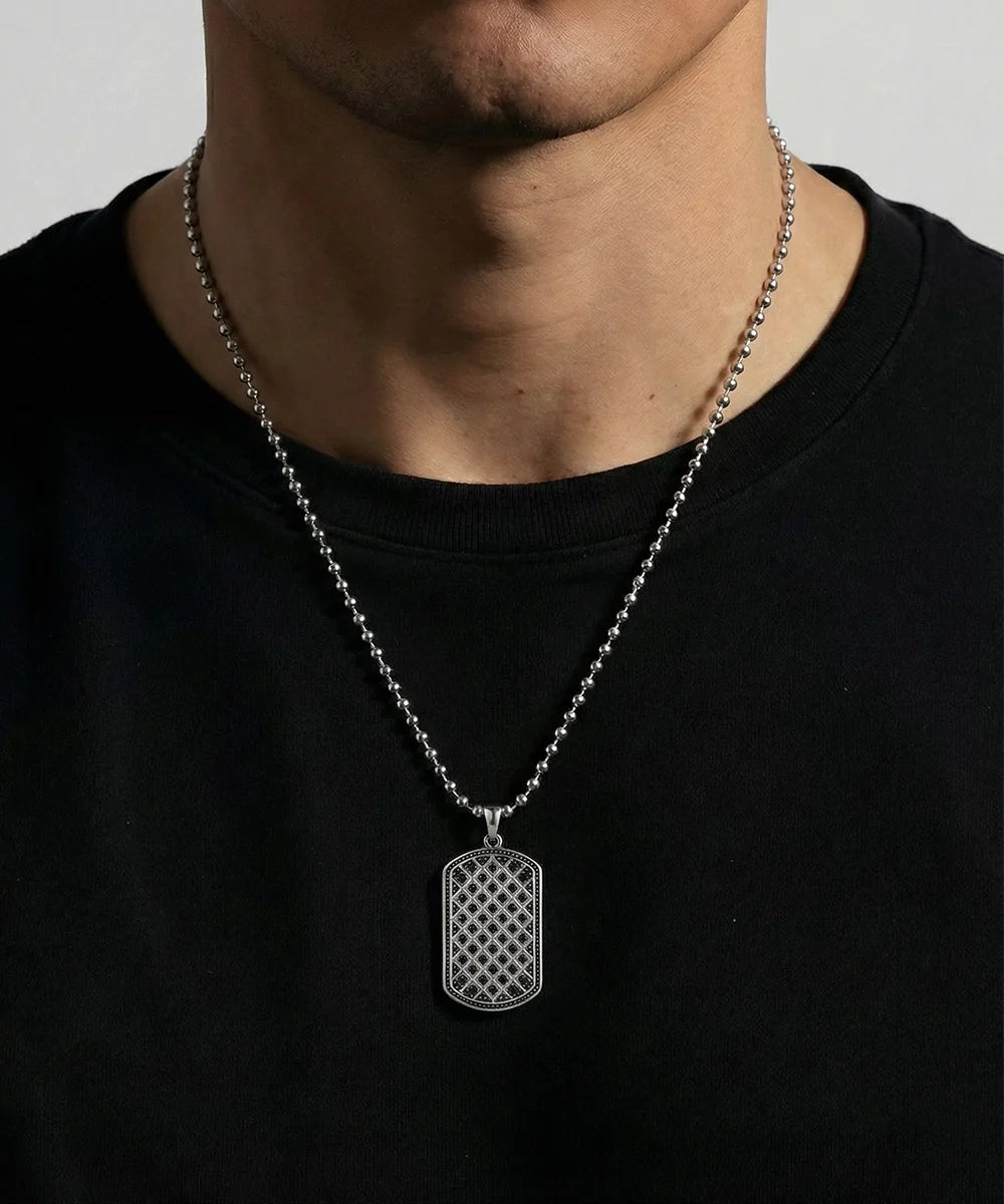 Close-up of black cubic zirconia dog tag pendant