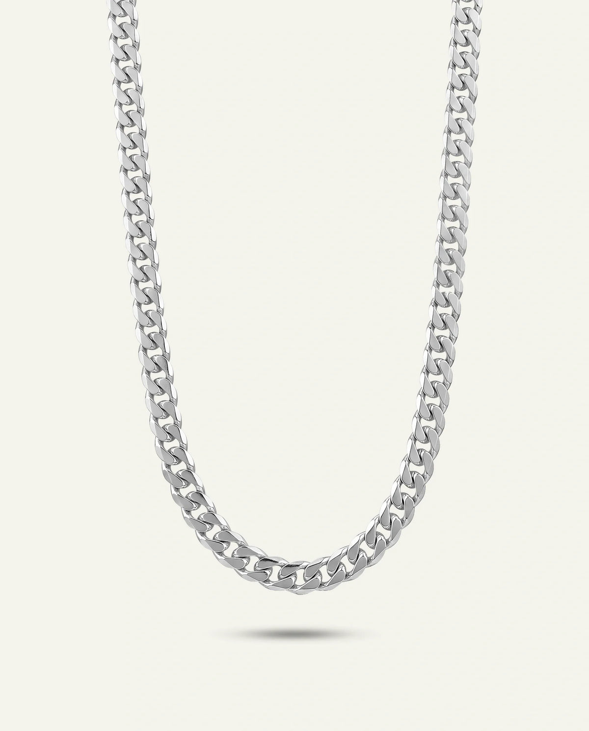 A men's silver Miami Cuban link chain necklace set against a light off-white background.