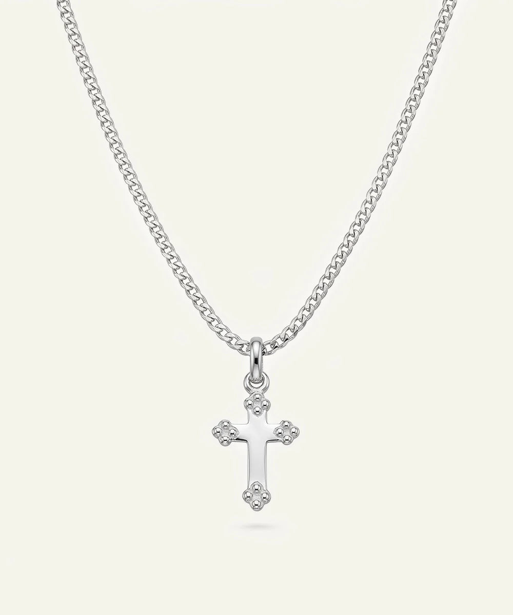 Close-up of silver cross pendant