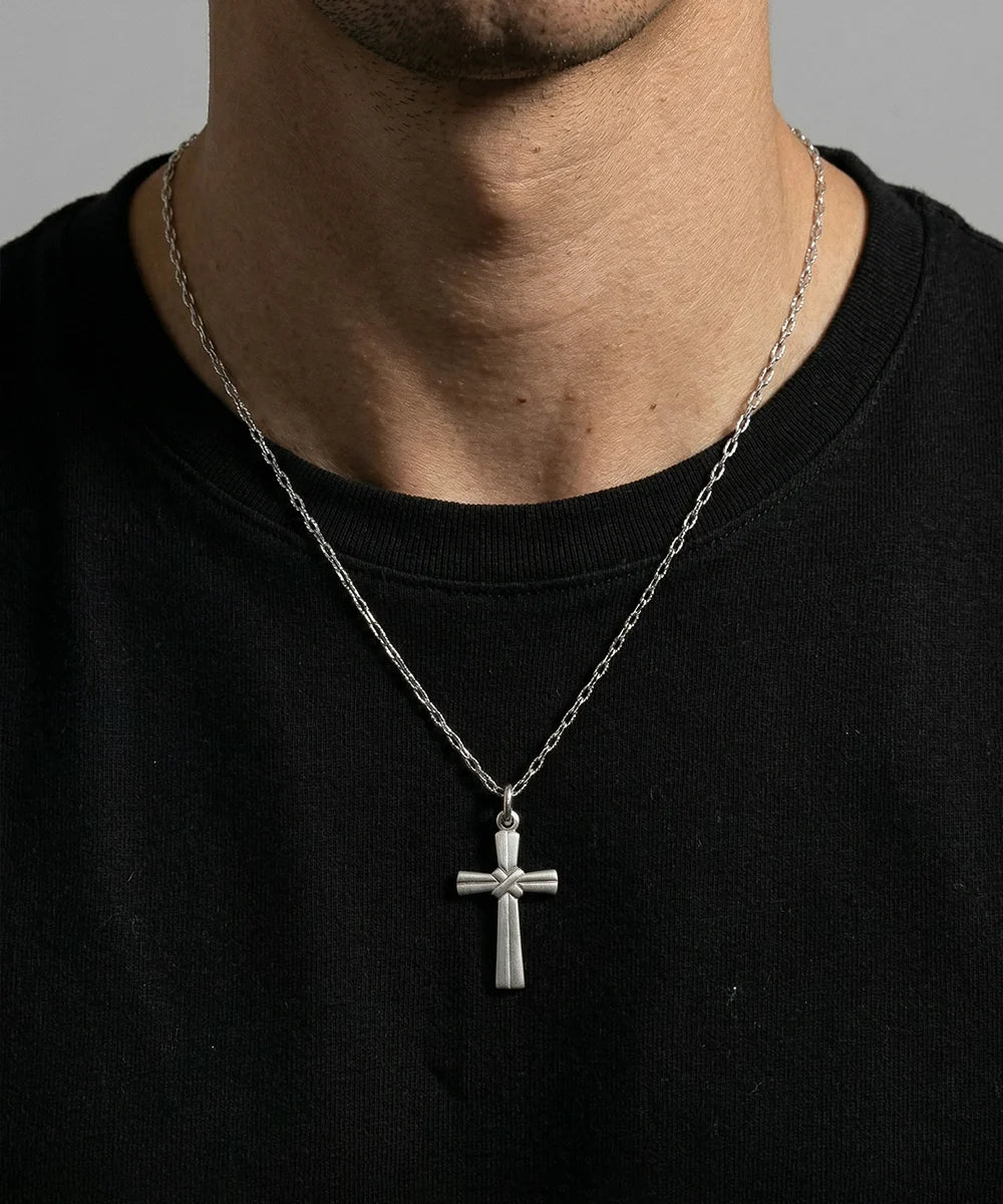 Close-up of silver cross pendant