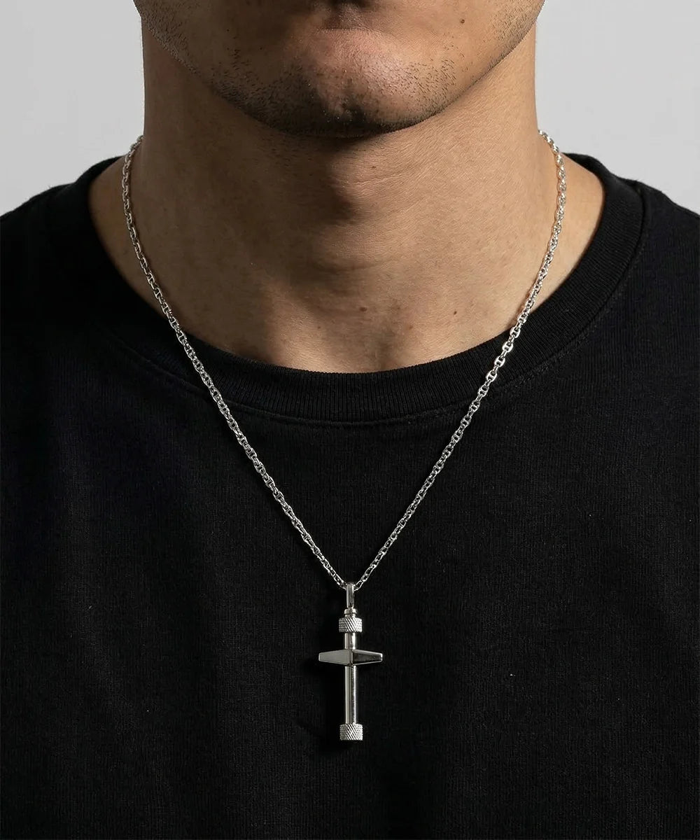 Close-up of silver cross pendant